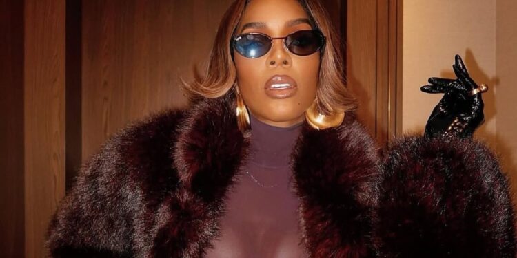 Kelly Rowland Wore a Burgundy ‘Sons of Gemini’ Dress and a $1,490 Retrofete Faux Fur Coat to Broadway