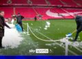 Sabotage!?!? Nev shovels snow onto Anfield pitch and Carra removes it!
