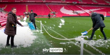 Sabotage!?!? Nev shovels snow onto Anfield pitch and Carra removes it!