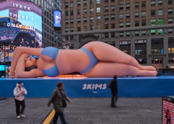 Kim Kardashian Promotes Skims Swim with a Blue Bikini Clad Blow Up Doll in Times Square