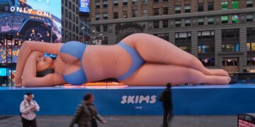 Kim Kardashian Promotes Skims Swim with a Blue Bikini Clad Blow Up Doll in Times Square