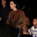 Kim Kardashian Stepped Out with her Son Psalm West in a Brown Fur Bomber Jacket with Black Leather Leggings
