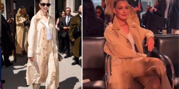 Anne Hathaway Attended the Ralph Lauren FW ’25 Show in a Khaki Trench Coat and Sequined Jeans