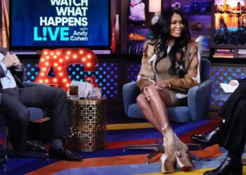 Brit Eady Appeared on WWHL in a Brown Vintage Roberto Cavalli Dress with a Dior Handbag and Christian Louboutin Boots