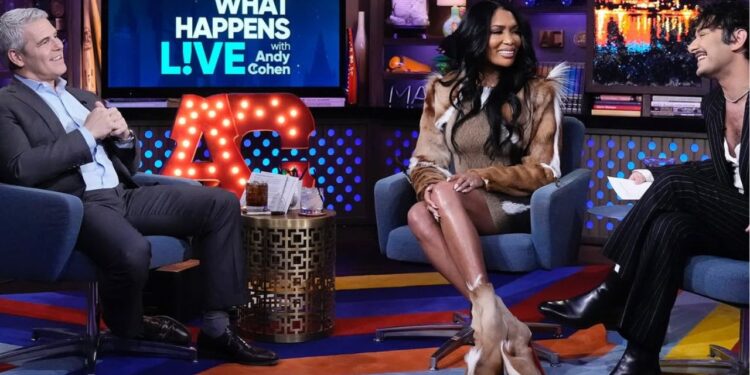 Brit Eady Appeared on WWHL in a Brown Vintage Roberto Cavalli Dress with a Dior Handbag and Christian Louboutin Boots