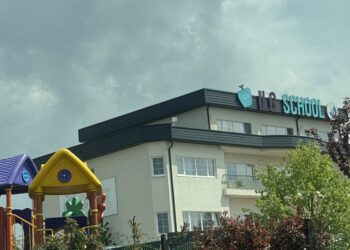 Front view of ILG School in Pristina, Kosovo, displaying the school's name and IB accreditation logo on the exterior wall.