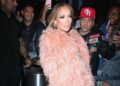 Jennifer Lopez Wore a Peach $835 “The New Arrival” Dress with a Feather Bolero and FEMME LA Heels to the Ring Them Bells benefit Concert in New York