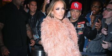 Jennifer Lopez Wore a Peach $835 “The New Arrival” Dress with a Feather Bolero and FEMME LA Heels to the Ring Them Bells benefit Concert in New York