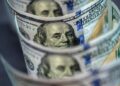 Dollar sinks to three-year low on Trump tariff threat