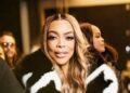 Wendy Williams Spotted at LaQuan Smith NYFW Show win a Black and White Fur Coat with Black Mini Shorts and a Snakeskin Hermes Bag